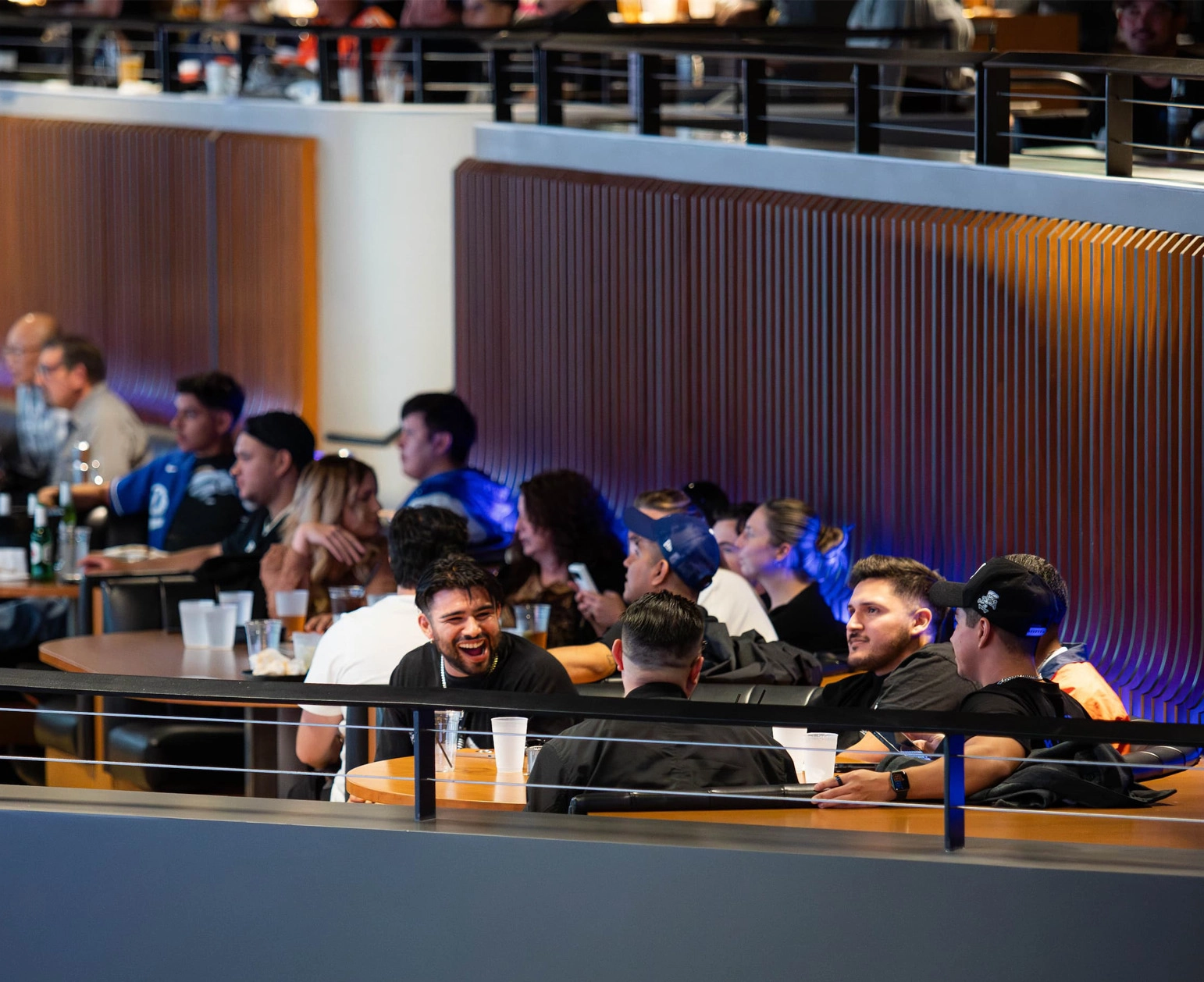 Reserved group seating in Cosm's Hall with large display screens