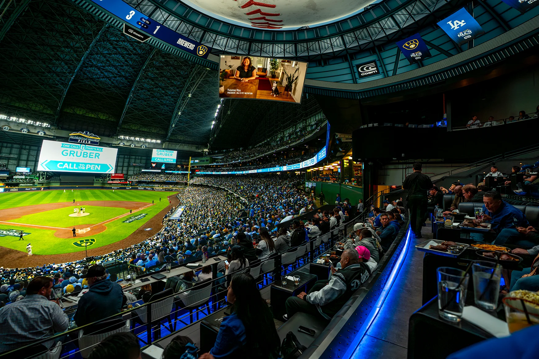 Baseball fans watching a Dodgers game at Cosm Los Angeles