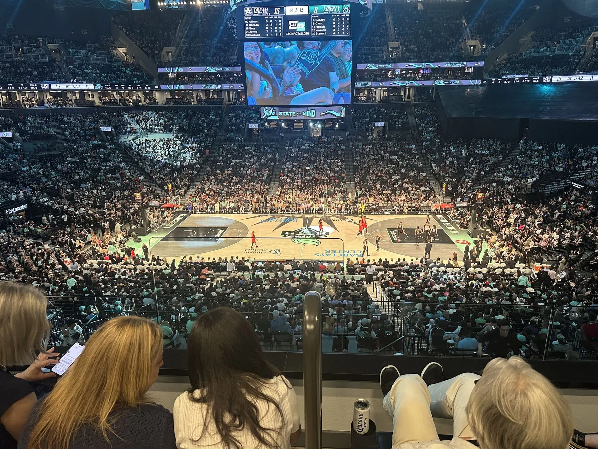Basketball players competing as fans watch from arena seats